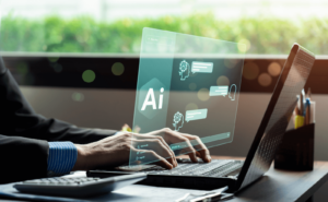Hands typing on a laptop keyboard with a screen displaying "AI" (AI in project management)