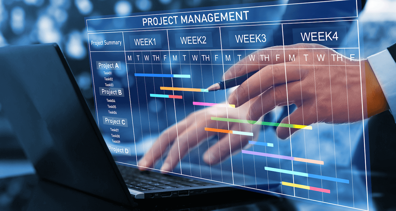 Hands typing on a laptop that has a project management tool pulled up (project management phases)