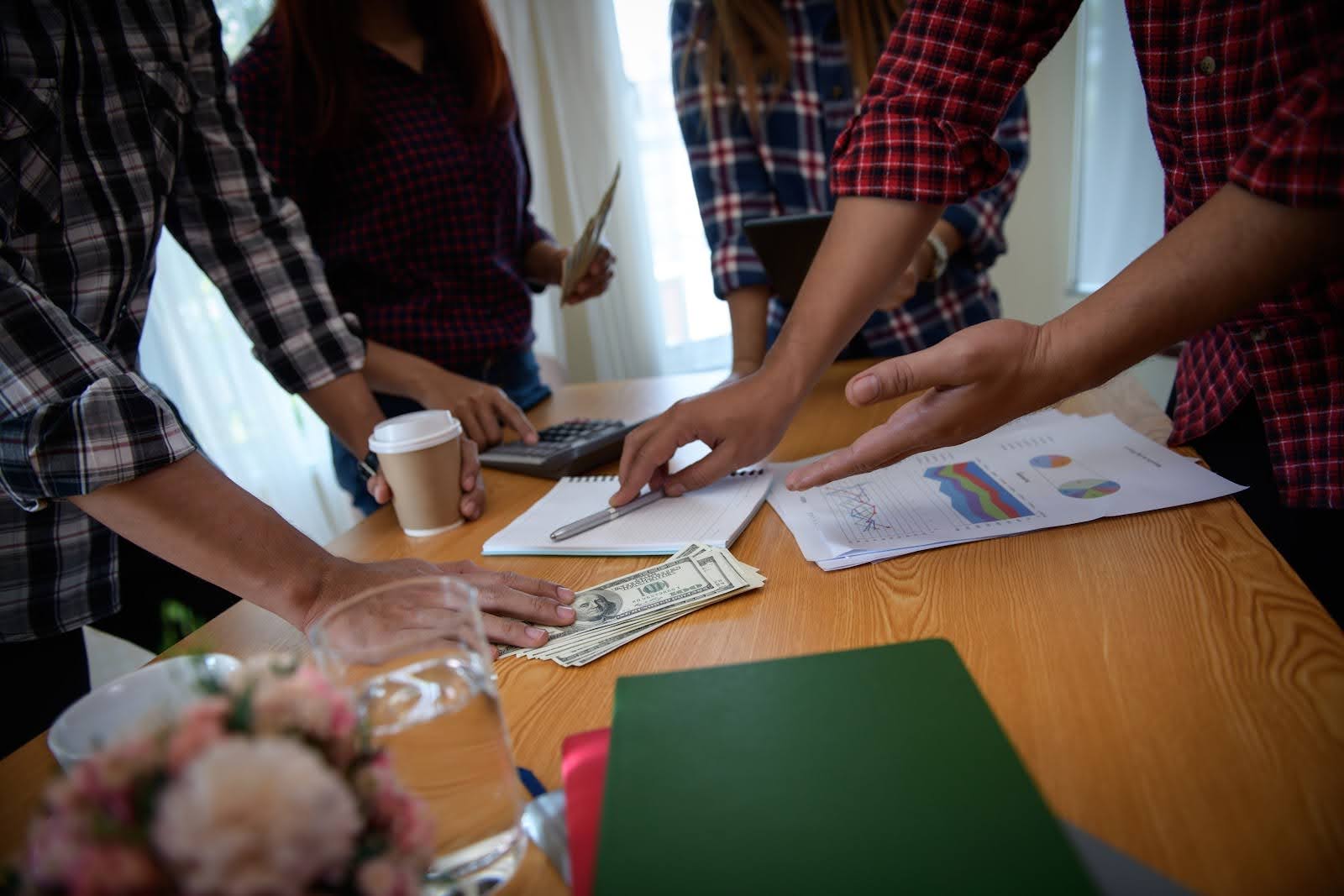 Workers at a table looking over nonprofit audit checklist