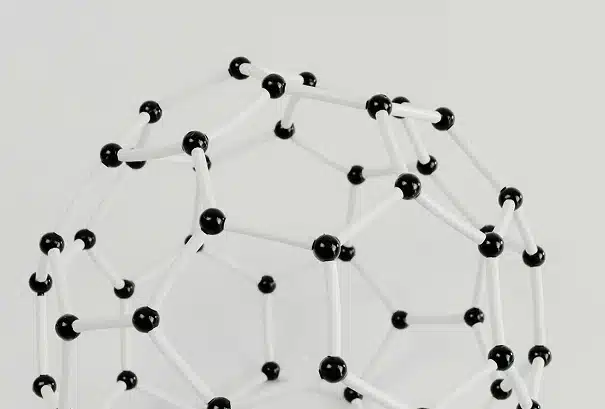 A geometric molecular model made of black and white sticks and spheres, arranged in a hollow, spherical shape representing a buckyball (C60 fullerene) against a plain white background.