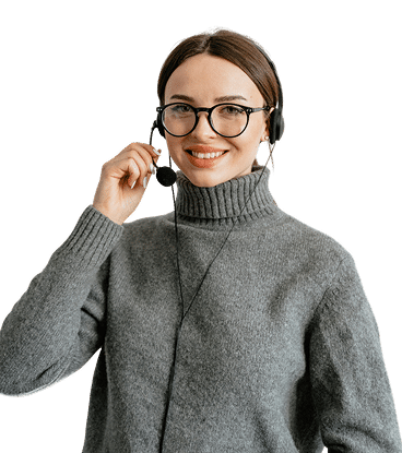 A woman wearing glasses and a gray turtleneck sweater is smiling while holding her headset’s microphone, suggesting she is a customer service representative assisting clients with deltek implementation.