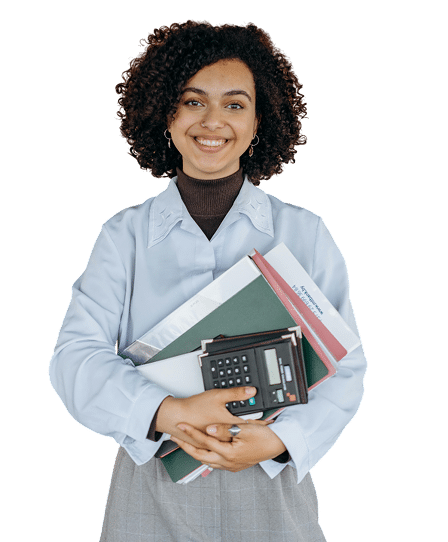 A smiling woman with curly hair holds a calculator, folders, and papers in her arms. She is dressed in a light blue shirt and stands against a plain, white background (sage intacct consultant).