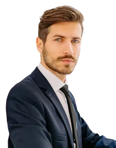 A man with short brown hair and a trimmed beard wearing a dark suit, white shirt, and black tie looks confidently at the camera against a plain background.