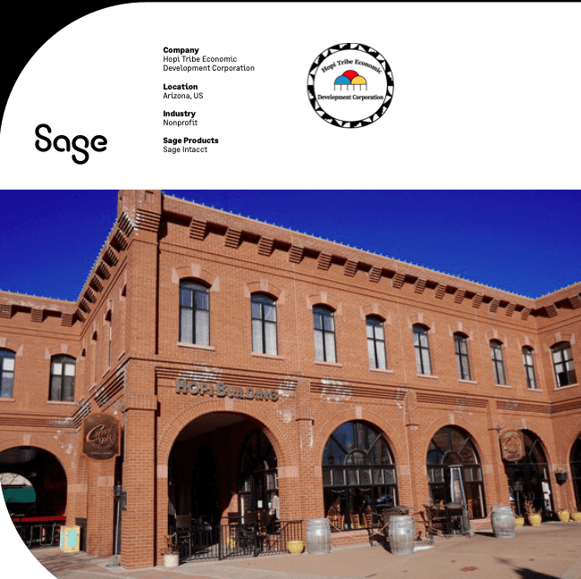 A large red-brick building with multiple arches and windows under a clear blue sky; text details Hoyt Tribe Economic Development Corporation, located in Arizona, US, nonprofit, using Sage Intacct.
